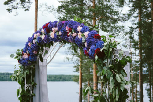 Wedding arch and grey chairs with peonies standing in ceremony a